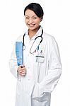 Young Doctor Holding Clipboard Stock Photo