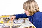 Young Dutch Girl Making Jigsaw Puzzle On Table Stock Photo