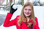 Young Dutch Woman Dressed In Red Holding Snowball Stock Photo
