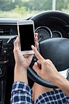 Young Female Driver Using Touch Screen Smartphone In A Car Stock Photo