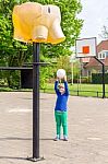 Young Girl Aiming Ball At Basket Like Elephant Stock Photo