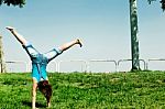 Young girl Doing cartwheel Stock Photo