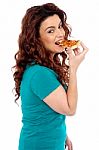 Young Girl Eating Pizza Stock Photo