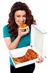 Young Girl Eating Pizza Stock Photo