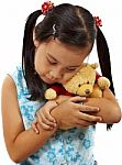 Young Girl Hugging Teddy Bear Stock Photo