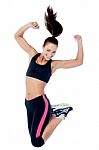 Young Girl In Sportswear Jumping With Joy Stock Photo
