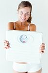 Young Girl In Underwear Holding Scales Stock Photo
