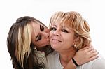Young Girl Kissing Her Mom Stock Photo