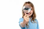 Young Girl Playing Around With Magnifying Glass Stock Photo