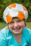 Young Girl Wearing Leather Football On Head Stock Photo