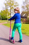 Young Girl With Pink Step Looking Back Stock Photo