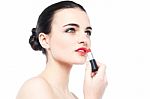 Young Gorgeous Woman Applying Lipstick Stock Photo