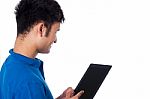 Young Guy Browsing On Tablet Device Stock Photo