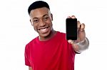 Young Guy Displaying Brand New Cellphone Stock Photo