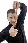 Young Guy With Thumbs Up And Down Stock Photo