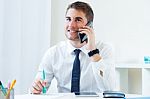 Young Handsome Man Working In His Office With Mobile Phone Stock Photo