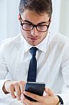 Young Handsome Man Working In His Office With Mobile Phone Stock Photo