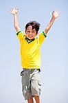 Young Kid With Raised Arms Stock Photo