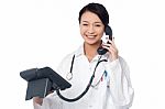 Young Lady Doctor Answering Phone Call Stock Photo
