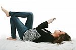 Young Lady Lying On Bed Stock Photo