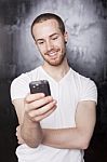 Young Male Reading Sms Stock Photo
