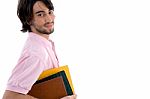 Young male Student Holding Books Stock Photo