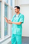 Young Male Surgeon Using Digital Tablet Stock Photo