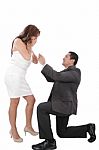 Young Man Down On His Knee Proposing To Girlfriend Stock Photo