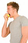 Young Man eating An Apple Stock Photo