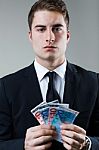 Young Man In Formalwear Holding Money Stock Photo