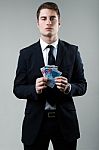 Young Man In Formalwear Holding Money Stock Photo