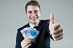 Young Man In Formalwear Holding Money Stock Photo