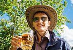 Young Man Is Drinking Beer In The Park Stock Photo