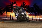 Young Man Riding Big Bike Motorcycle On Asphalt Roads Against Be Stock Photo