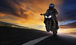 Young Man Riding Motorcycle On Asphalt Highways Road With Profes Stock Photo