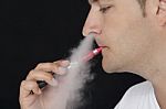 Young Man Smoking An Electronic Cigarette Stock Photo