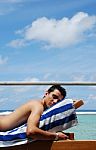 Young Man Sunbathing In A Maldives Resort Room Stock Photo