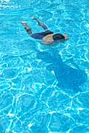 Young Man Swimming Underwater Stock Photo