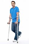 Young Man With Crutches Trying To Walk Stock Photo