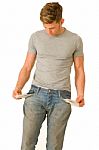 Young Man With Empty Pockets Stock Photo