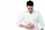 Young Man With Strong Stomach Pain Stock Photo