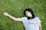 Young Model Laying In The Grass Stock Photo
