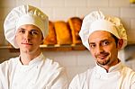 Young Smiling Chefs Posing In Bakery Stock Photo