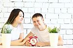 Young Smiling Couple Sitting At The Table Stock Photo