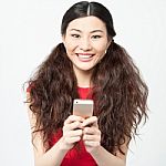 Young Smiling Girl Using Cell Phone Stock Photo