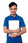 Young Smiling Guy Holding Laptop Stock Photo
