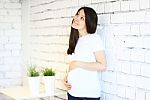 Young Smiling Pregnant Woman Stock Photo