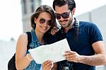 Young Tourist Couple In Town Holding A Map Stock Photo
