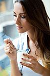 Young Woman At Home Eating Yogurt Stock Photo