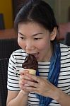 Young Woman Eating Ice Cream Stock Photo